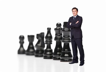 Businessman in front of black chess pieces Foto de stock - Super Valor sin royalties y Suscripción, Código: 400-05714819