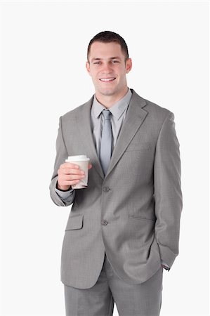 Portrait of a young businessman holding a cup of tea against a white background Stock Photo - Budget Royalty-Free & Subscription, Code: 400-05714829