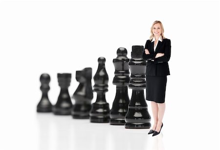 Businesswoman in front of black chess pieces on white background Fotografie stock - Microstock e Abbonamento, Codice: 400-05714820