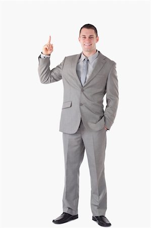 simsearch:400-05714996,k - Portrait of a businessman pointing at a copy space against a white background Foto de stock - Super Valor sin royalties y Suscripción, Código: 400-05714859