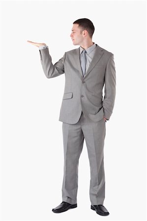 simsearch:400-05714996,k - Portrait of a businessman presenting something against a white background Foto de stock - Super Valor sin royalties y Suscripción, Código: 400-05714860