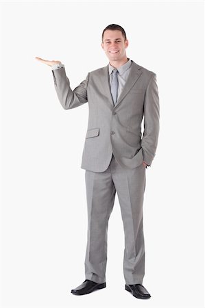 simsearch:400-05714996,k - Portrait of a smiling businessman presenting something against a white background Foto de stock - Super Valor sin royalties y Suscripción, Código: 400-05714861