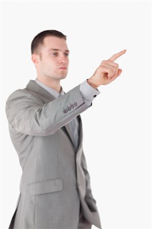 Portrait of a businessman touching something against a white background Stock Photo - Budget Royalty-Free & Subscription, Code: 400-05714874