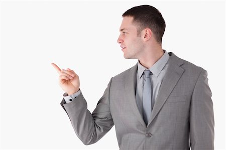 simsearch:400-05714996,k - Businessman pointing at something against a white background Foto de stock - Super Valor sin royalties y Suscripción, Código: 400-05714907