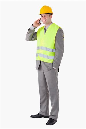 simsearch:400-05714957,k - Portrait of a smiling builder making a phone call against a white background Stock Photo - Budget Royalty-Free & Subscription, Code: 400-05714945