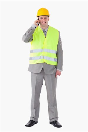simsearch:400-05714957,k - Portrait of a young builder making a phone call against a white background Stock Photo - Budget Royalty-Free & Subscription, Code: 400-05714946