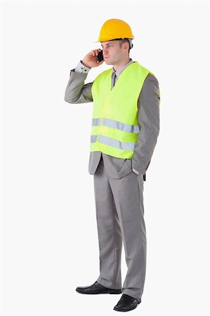 simsearch:400-05714957,k - Portrait of a builder making a phone call against a white background Stock Photo - Budget Royalty-Free & Subscription, Code: 400-05714943
