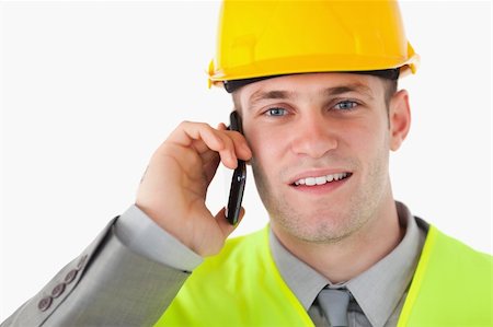 simsearch:400-05714957,k - Close up of a builder making a phone call against a white background Stock Photo - Budget Royalty-Free & Subscription, Code: 400-05714954