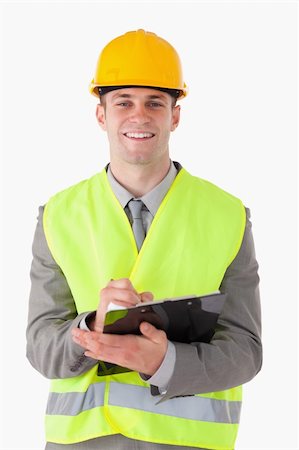 simsearch:400-05714957,k - Portrait of a smiling builder taking notes while smiling at the camera Stock Photo - Budget Royalty-Free & Subscription, Code: 400-05714957