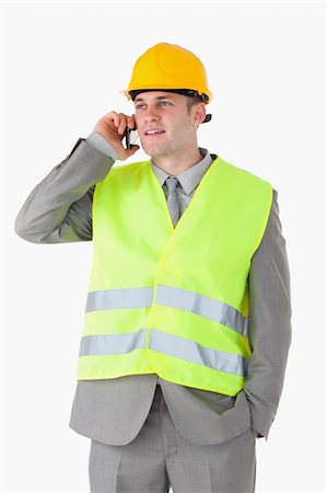 simsearch:400-05714957,k - Portrait of a handsome builder using his cellphone against a white background Stock Photo - Budget Royalty-Free & Subscription, Code: 400-05714951
