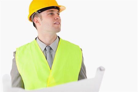 simsearch:400-04485437,k - Builder holding a plan while looking around against a white background Stock Photo - Budget Royalty-Free & Subscription, Code: 400-05714972