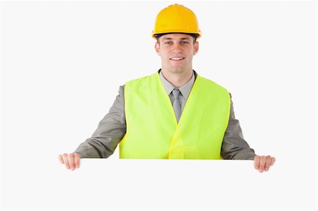 engineer background - Builder holding a blank panel against a white background Stock Photo - Budget Royalty-Free & Subscription, Code: 400-05714973