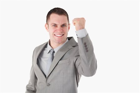 simsearch:400-04129711,k - Young businessman with his fist up against a white background Stock Photo - Budget Royalty-Free & Subscription, Code: 400-05714995