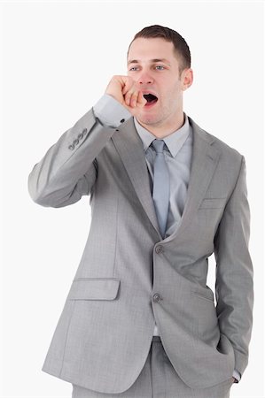 simsearch:400-04188055,k - Portrait of a businessman yawning against a white background Stockbilder - Microstock & Abonnement, Bildnummer: 400-05715000