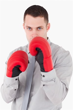 simsearch:400-05898249,k - Portrait of a businessman ready to fight against a white background Stock Photo - Budget Royalty-Free & Subscription, Code: 400-05715030