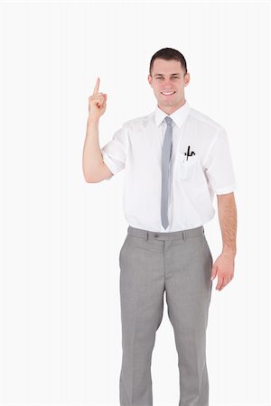 simsearch:400-05714996,k - Portrait of an office worker pointing at something against a white background Foto de stock - Super Valor sin royalties y Suscripción, Código: 400-05715080