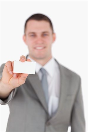 simsearch:400-05718318,k - Portrait of a businessman showing a blank business card against a white background Foto de stock - Super Valor sin royalties y Suscripción, Código: 400-05715105