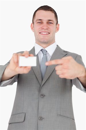 simsearch:400-05718318,k - Portrait of a businessman pointing at a blank business card against a white background Foto de stock - Super Valor sin royalties y Suscripción, Código: 400-05715166