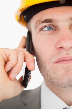 simsearch:400-05714957,k - Close up of a young architect making a phone call against a white background Stock Photo - Budget Royalty-Free & Subscription, Code: 400-05715194