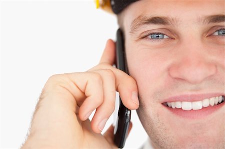 simsearch:400-05714957,k - Close up of a handsome architect making a phone call against a white background Stock Photo - Budget Royalty-Free & Subscription, Code: 400-05715196