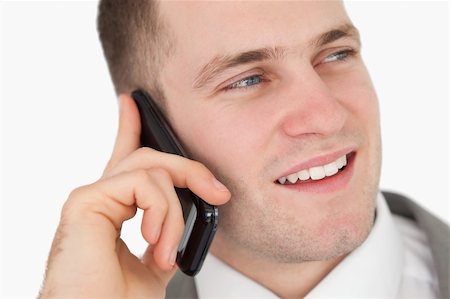 simsearch:400-05718346,k - Close up of a handsome entrepreneur making a phone call against a white background Foto de stock - Super Valor sin royalties y Suscripción, Código: 400-05715205