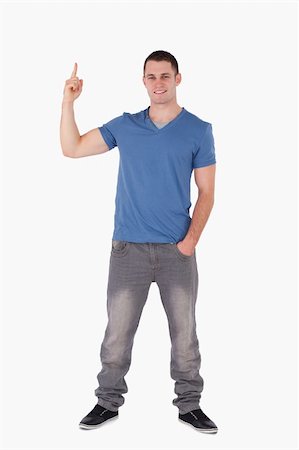 finger pointing up - Portrait of a smiling man pointing at something against a white background Stock Photo - Budget Royalty-Free & Subscription, Code: 400-05715219