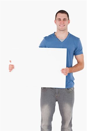 people holding blank billboards - Portrait of a young man holding a blank panel against a white background Stock Photo - Budget Royalty-Free & Subscription, Code: 400-05715307