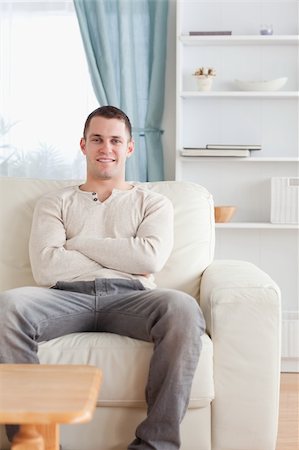 simsearch:400-05677069,k - Portrait of a man sitting on a couch in his living room Fotografie stock - Microstock e Abbonamento, Codice: 400-05715316