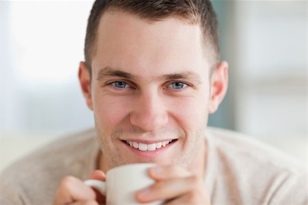 Close up of a man having a tea in his living room Stock Photo - Budget Royalty-Free & Subscription, Code: 400-05715376