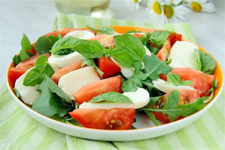 eating olive - Traditional Italian Caprese Salad mozzarella with tomatoes and basil Stock Photo - Budget Royalty-Free & Subscription, Code: 400-05715467