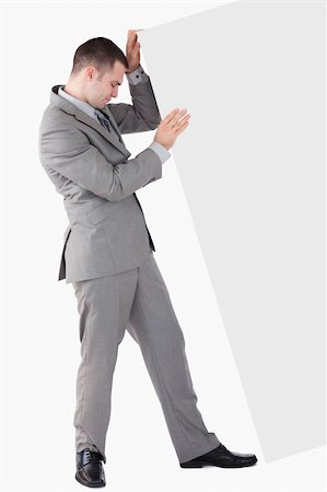 Portrait of businessman pushing a blank panel against a white background Stock Photo - Budget Royalty-Free & Subscription, Code: 400-05715682