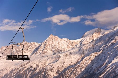 simsearch:400-03978663,k - Four chair lifts on the Alps background. Photographie de stock - Aubaine LD & Abonnement, Code: 400-05715842