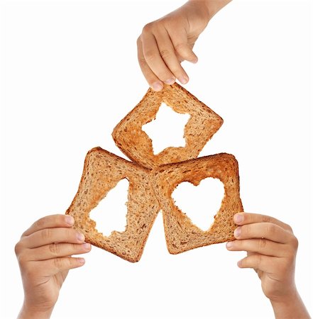 Kids hands holding bread with christmas symbols - love and sharing concept Stock Photo - Budget Royalty-Free & Subscription, Code: 400-05715888