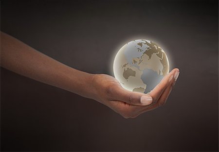 Feminine hand holding a glowing planet globe against a dark background Stock Photo - Budget Royalty-Free & Subscription, Code: 400-05716332