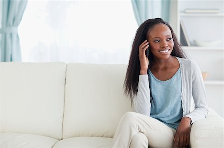 simsearch:400-05716936,k - Smiling woman phoning on sofa Stock Photo - Budget Royalty-Free & Subscription, Code: 400-05716396