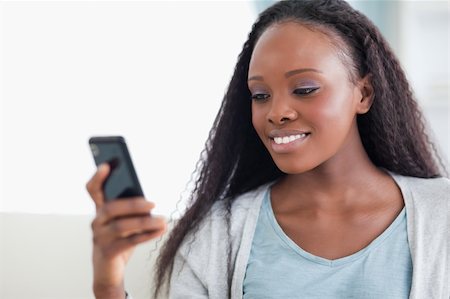 simsearch:400-05716936,k - Close up of smiling woman reading a text message Stock Photo - Budget Royalty-Free & Subscription, Code: 400-05716416