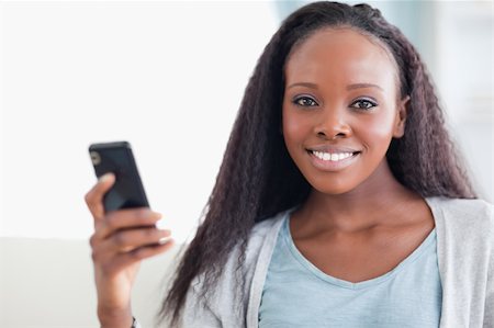 simsearch:400-05716936,k - Close up of smiling woman with her cellphone Stock Photo - Budget Royalty-Free & Subscription, Code: 400-05716418