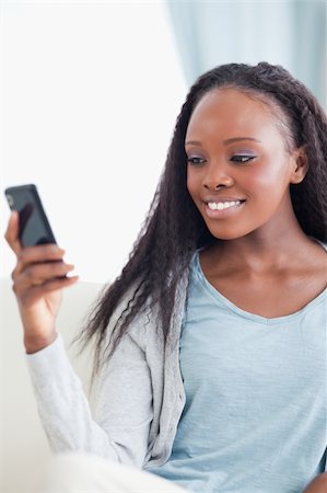 simsearch:400-05716936,k - Close up of smiling woman reading text message Stock Photo - Budget Royalty-Free & Subscription, Code: 400-05716420