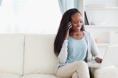 simsearch:400-05716936,k - Smiling woman with smartphone and notebook on the sofa Stock Photo - Budget Royalty-Free & Subscription, Code: 400-05716436