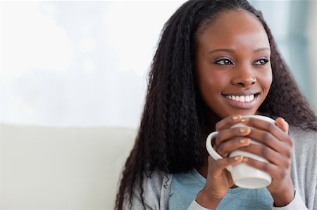 simsearch:400-05716909,k - Close up of smiling woman with a cup on sofa Stock Photo - Budget Royalty-Free & Subscription, Code: 400-05716502