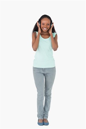 simsearch:400-05717354,k - Smiling woman listening to music on white background Stock Photo - Budget Royalty-Free & Subscription, Code: 400-05717298