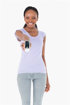 simsearch:400-05717420,k - Close up of smiling woman presenting her phone on white background Foto de stock - Super Valor sin royalties y Suscripción, Código: 400-05717344