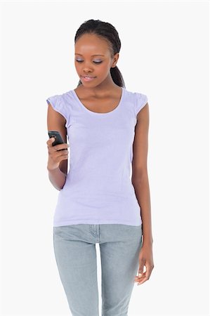 simsearch:400-05717420,k - Close up of young woman texting on white background Foto de stock - Super Valor sin royalties y Suscripción, Código: 400-05717341