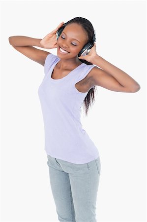 simsearch:400-05717354,k - Close up of smiling woman listening to music with headphones on white background Stock Photo - Budget Royalty-Free & Subscription, Code: 400-05717354