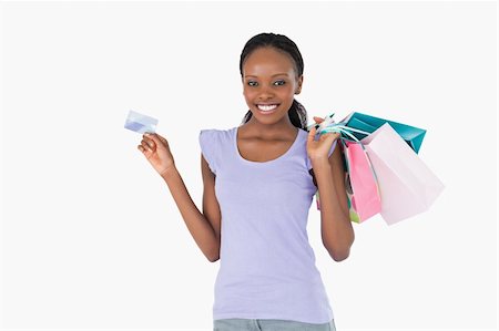 Happy smiling woman with her shopping and credit card on white background Stock Photo - Budget Royalty-Free & Subscription, Code: 400-05717378