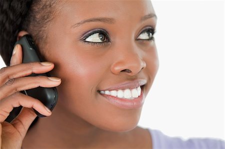 simsearch:400-05717420,k - Close up of smiling woman listening to caller on white background Foto de stock - Super Valor sin royalties y Suscripción, Código: 400-05717425