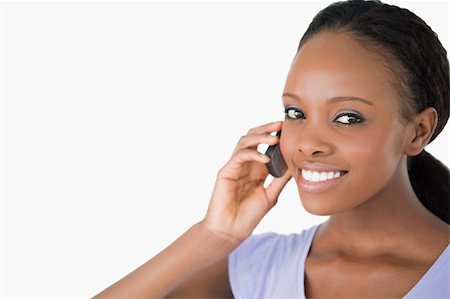 simsearch:400-05717420,k - Close up of smiling woman on the phone against a white background Foto de stock - Super Valor sin royalties y Suscripción, Código: 400-05717422