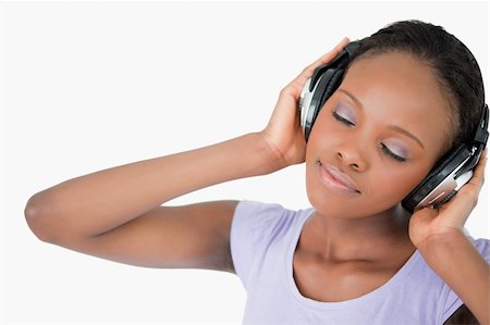 simsearch:400-05717354,k - Close up of smiling woman with headphones against a white background Stock Photo - Budget Royalty-Free & Subscription, Code: 400-05717447