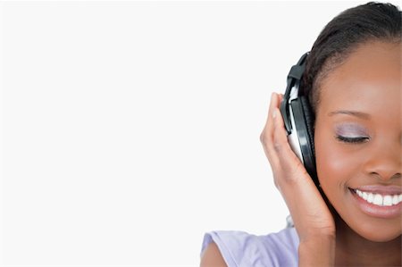 simsearch:400-05717354,k - Close up of smiling young woman enjoying music on white background Stock Photo - Budget Royalty-Free & Subscription, Code: 400-05717452