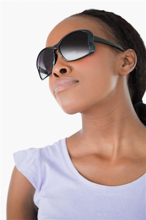 Close up of young woman wearing her sunglasses against a white background Stock Photo - Budget Royalty-Free & Subscription, Code: 400-05717460